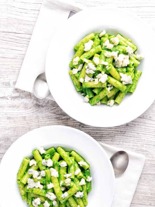 Overhead bowls of wild garlic pesto pasta with rigatoni.