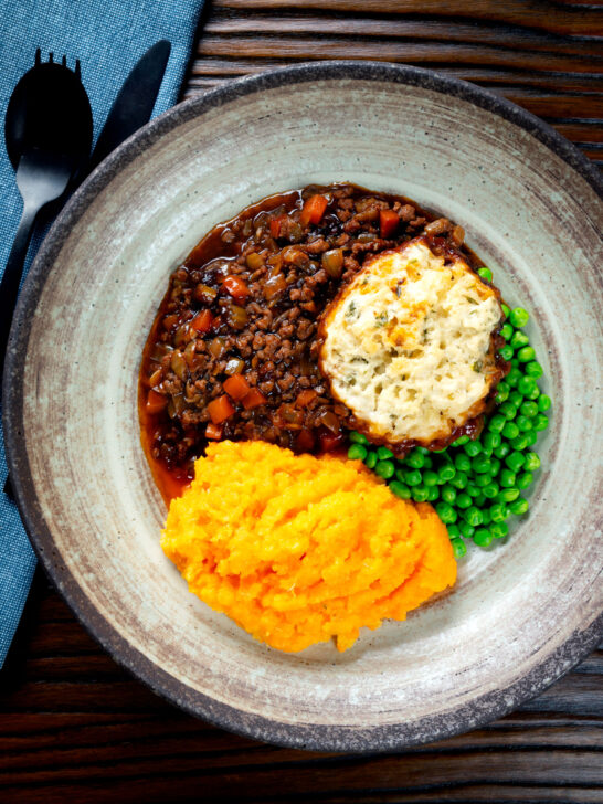 Overhead mince and dumplings stew served with swede and carrot mash.