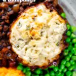 Close-up overhead suet dumpling on a minced beef stew, with peas and swede & carrot mash featuring a title overlay.