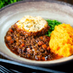 Mince and dumplings stew served with swede and carrot mash.