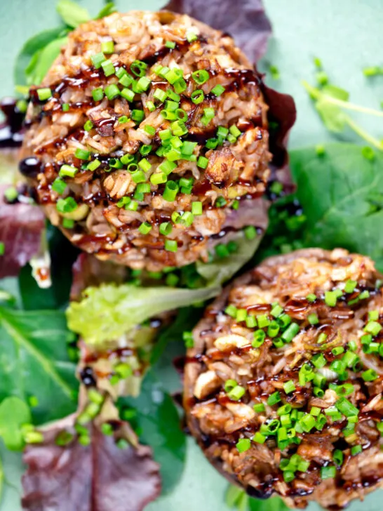 Overhead close-up brown rice stuffed mushrooms with cheddar cheese and balsamic.