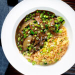 Overhead Chinese takeaway style beef curry served with egg fried rice.