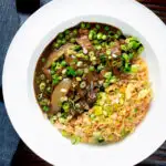 Overhead Chinese takeaway style beef curry served with egg fried rice.