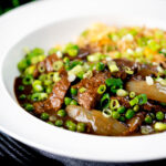 Chinese takeaway style beef and onion curry served with egg fried rice featuring a title overlay.