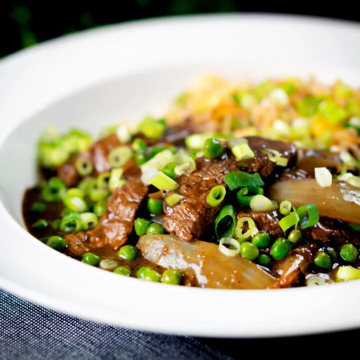 Chinese takeaway style beef curry with onions and peas, served with egg fried rice.