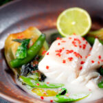 Poached cod loin in coconut milk with pak choi and chilli.