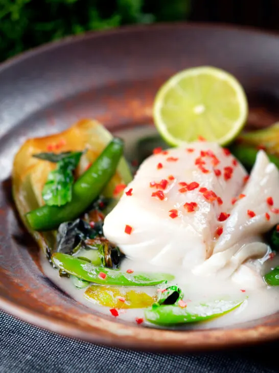 Poached cod loin in coconut milk with pak choi and chilli.