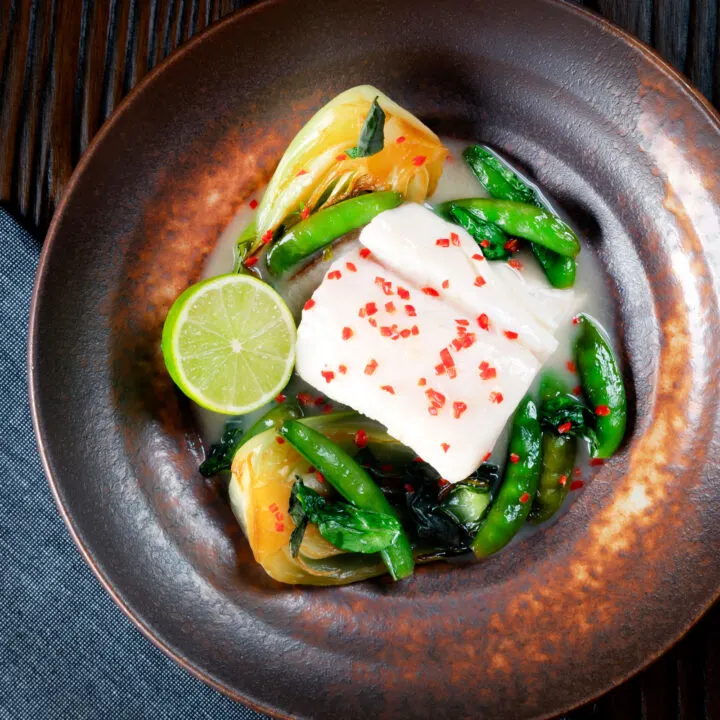 Poached cod loin in coconut milk with pak choi, sugar snap peas and chilli.