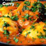 Close-up Indian inspired egg masala curry with fresh coriander featuring a title overlay.