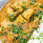 Overhead, close-up fruity pineapple and chicken curry with rice, coriander and naan.