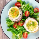 Overhead balsamic vinegar caramelised onion and goats cheese stuffed Portobello mushrooms featuring a title overlay.