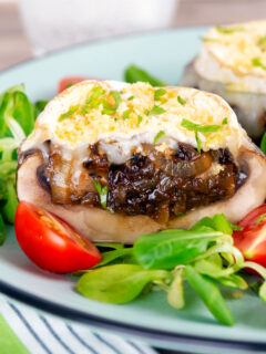 Close-up balsamic vingegar caramelised onion and goats cheese stuffed Portobello mushrooms.