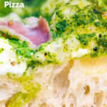 Close up section of the overnight crust on a goat cheese and pesto pizza featuring a title overlay.