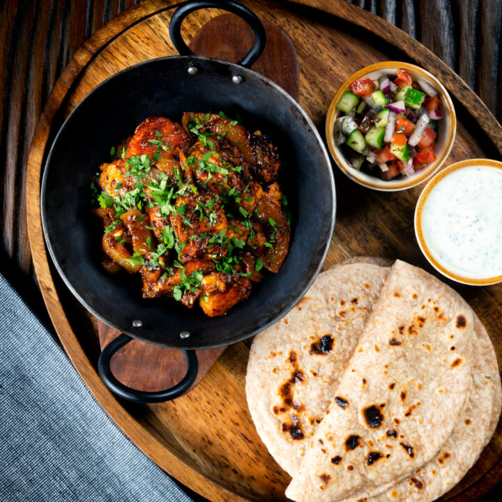 Halloumi cheese curry served with homemade chapatis, raita and kachumber salad.