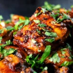 Close-up peppery halloumi cheese curry with fresh coriander.