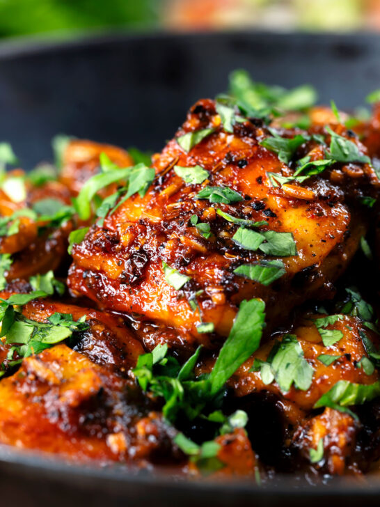 Close-up peppery halloumi cheese curry with fresh coriander.