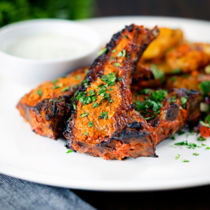 Tandoori lamb chops with roasted Bombay potatoes and raita.