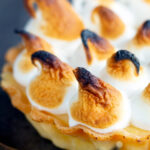 Close up mini lemon meringue pie tartlet with Italian meringue.