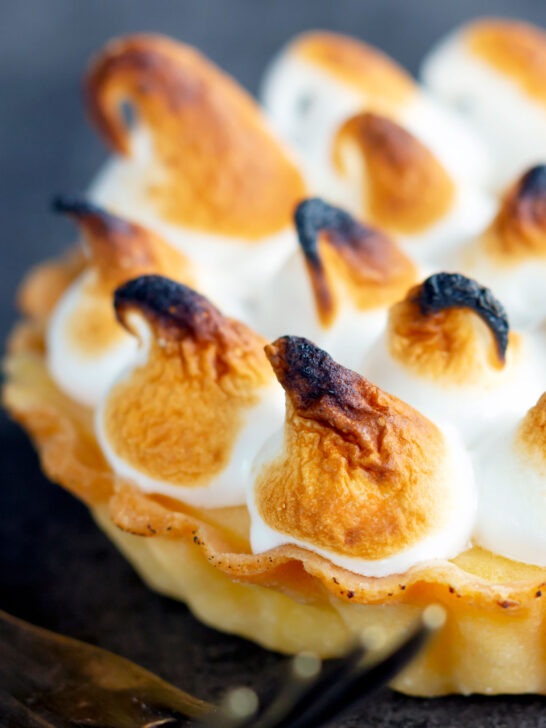 Close up mini lemon meringue pie tartlet with Italian meringue.