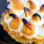 Close up mini lemon meringue pie tartlet with Italian meringue featuring a title overlay.