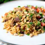 Lamb kabsa, Saudi Arabian rice with almonds and raisins served with chopped salad.