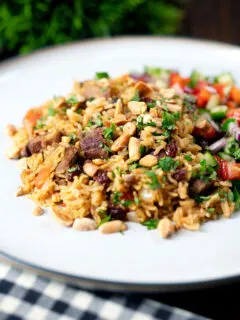 Lamb kabsa, Saudi Arabian rice with almonds and raisins served with chopped salad.