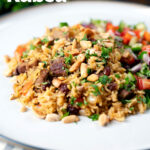 Lamb kabsa, Saudi Arabian rice with almonds and raisins served with chopped salad featuring a title overlay.