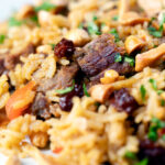 Close-up lamb kabsa, Saudi Arabian rice with almonds and raisins.