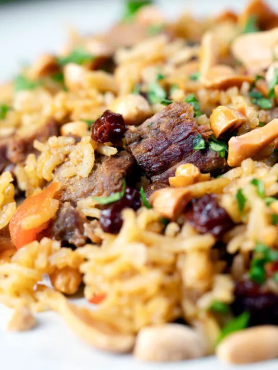 Close-up lamb kabsa, Saudi Arabian rice with almonds and raisins.