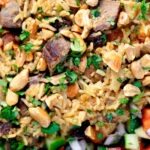 Overhead close-up lamb kabsa, Saudi Arabian rice with almonds and raisins.