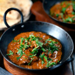 Lamb madras curry fakeaway served with homemade chapatis.