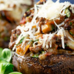 Close-up beef mince stuffed Portobello mushrooms with parmesan cheese.