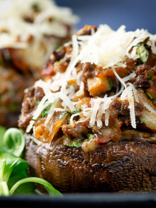 Close-up beef mince stuffed Portobello mushrooms with parmesan cheese.