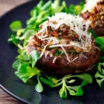 Beef mince stuffed Portobello mushrooms with parmesan cheese and lambs lettuce featuring a title overlay.