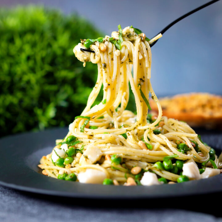 Pesto pasta (spaghetti) with peas, goats cheese and pine nuts.