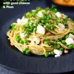 Pesto pasta with aged goat cheese and peas served with garlic bread featuring a title overlay.