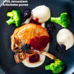 Overhead pork chops with a cider and fresh blackberry sauce with Jerusalem artichoke puree featuring a title overlay.