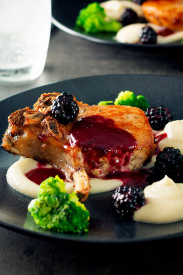Pork chops with a cider and fresh blackberry sauce with Jerusalem artichoke puree.