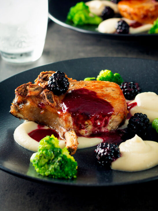 Pork chops with a cider and fresh blackberry sauce with Jerusalem artichoke puree.