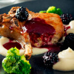Baked pork chop with a cider and blackberry sauce with pureed Jerusalem artichokes.