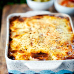 Hungarian layered potato bake, rakott krumpli served with pickles.