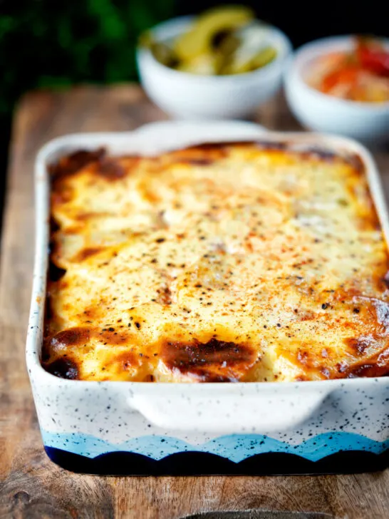 Hungarian layered potato bake, rakott krumpli served with pickles.