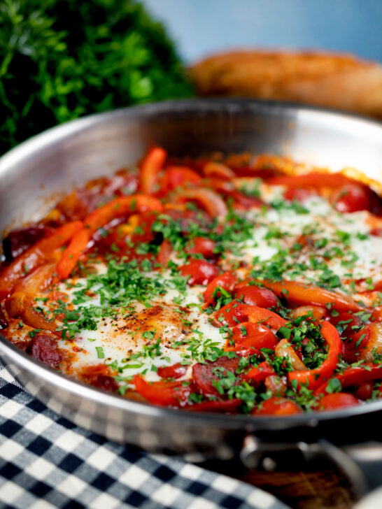 Chorizo shakshuka a baked in a tomato sauce with egg, pepper and onion.