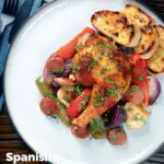 Overhead Spanish chicken and chorizo tray bake with vegetables served with toasted bread featuring a title overlay.