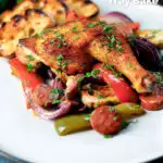 Spanish chicken and chorizo tray bake with vegetables served with toasted bread featuring a title overlay.