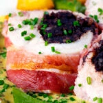 Close-up black pudding stuffed chicken breast wrapped in bacon.