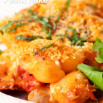 Close-up cheesy chicken and chorizo pasta bake served on a plate, featuring a title overlay.