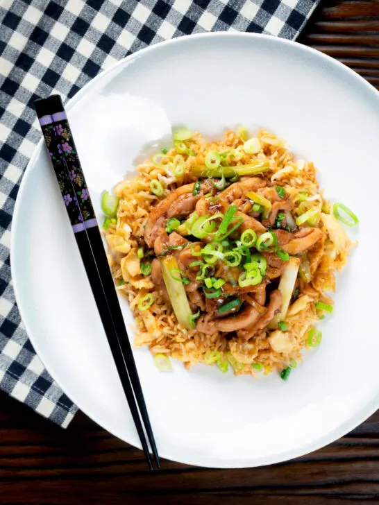 Overhead ginger chicken with garlic and spring onions served with egg fried rice.