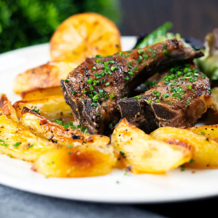 Greek lamb chops or cutlets (paidakia) with garlic potatoes and lemon.