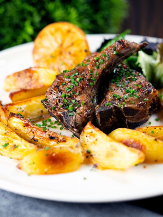 Greek lamb chops (paidakia) served with lemon garlic potatoes.